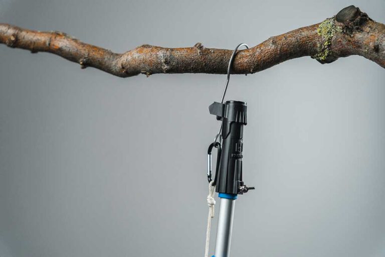 Aufhängen: Hänge den Gegenstand sicher an den Befestigungspunkt deiner Wahl (Ast, Regenrinne, Haken, metallische Fläche, …) und löse die Verbindung, indem du die Teleskopstange nach unten abziehst.